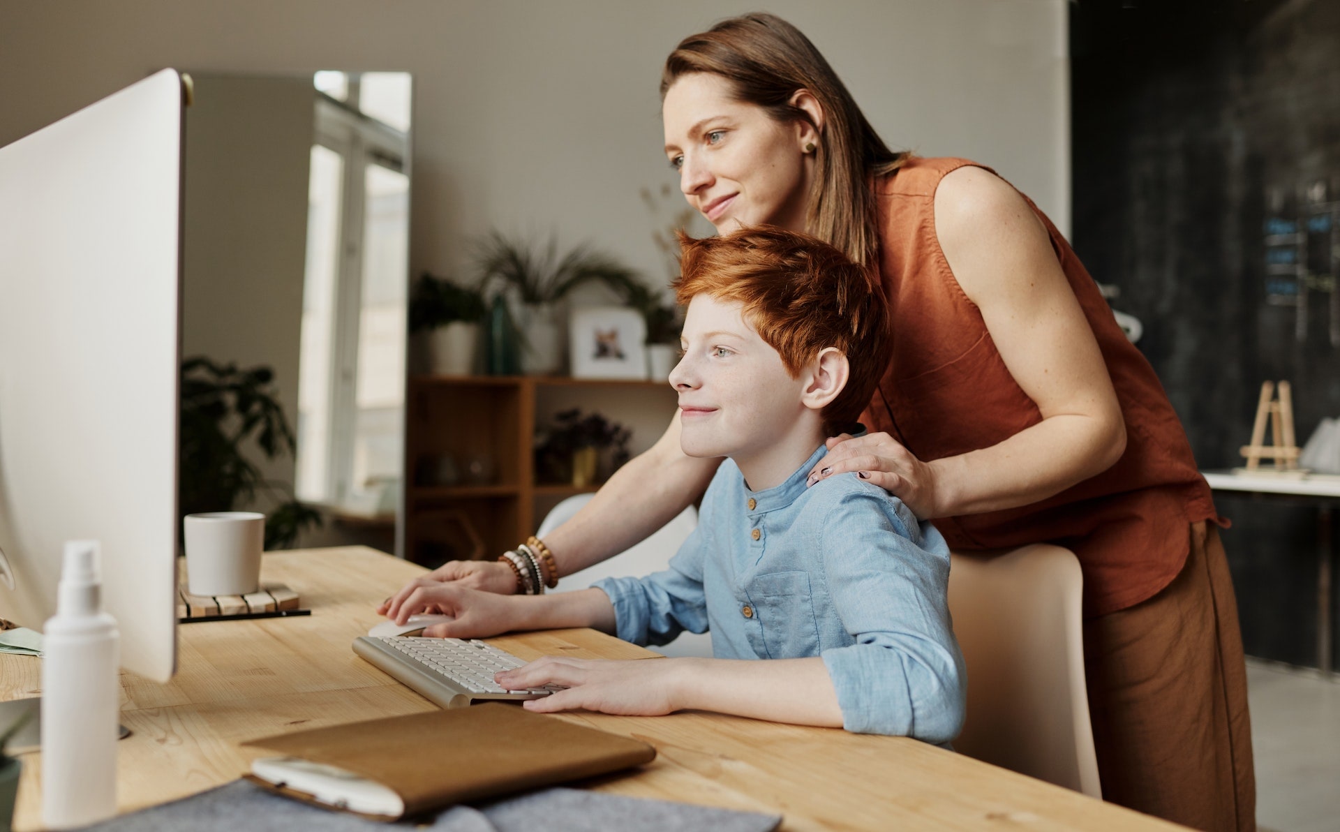 mom teaching her son on a computer